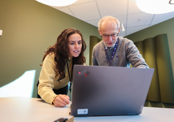 Man and woman looking at computer